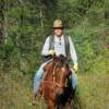 Bob Wilson horseback riding on Kota in the mountains east of  Moose Creek Estates - Premier  Idaho acreage for sale.