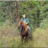 Beth Wilson enjoying Idaho horseback riding in the mountains east of Moose Creek Estates premier mountain property for sale.