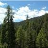 Idaho fishing property view from the West on Lot 20 bordering the North Fork of the Salmon River for a beautiful Idaho waterfront property location at Moose Creek Estates premier Rocky Mountain real estate!