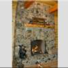 View of the magnificent river stone fireplace with 48" firebox holding up to 4 foot logs.