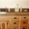 Bathroom cabinets and granite slab countertops in the bathroom at Moose Creek Estates Model Home a premier Rocky Mountain Real Estate